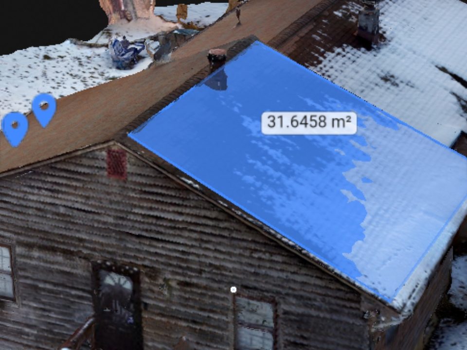 3D photogrammetry model of a house built from drone images, with one roof plane outlined and measured